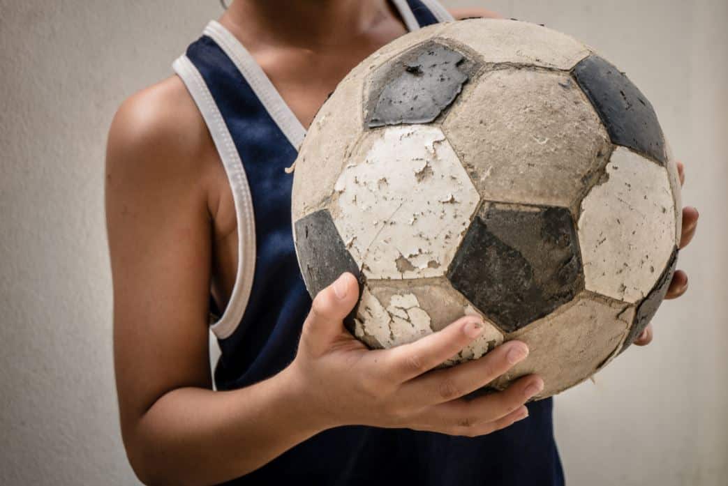 child holding a football