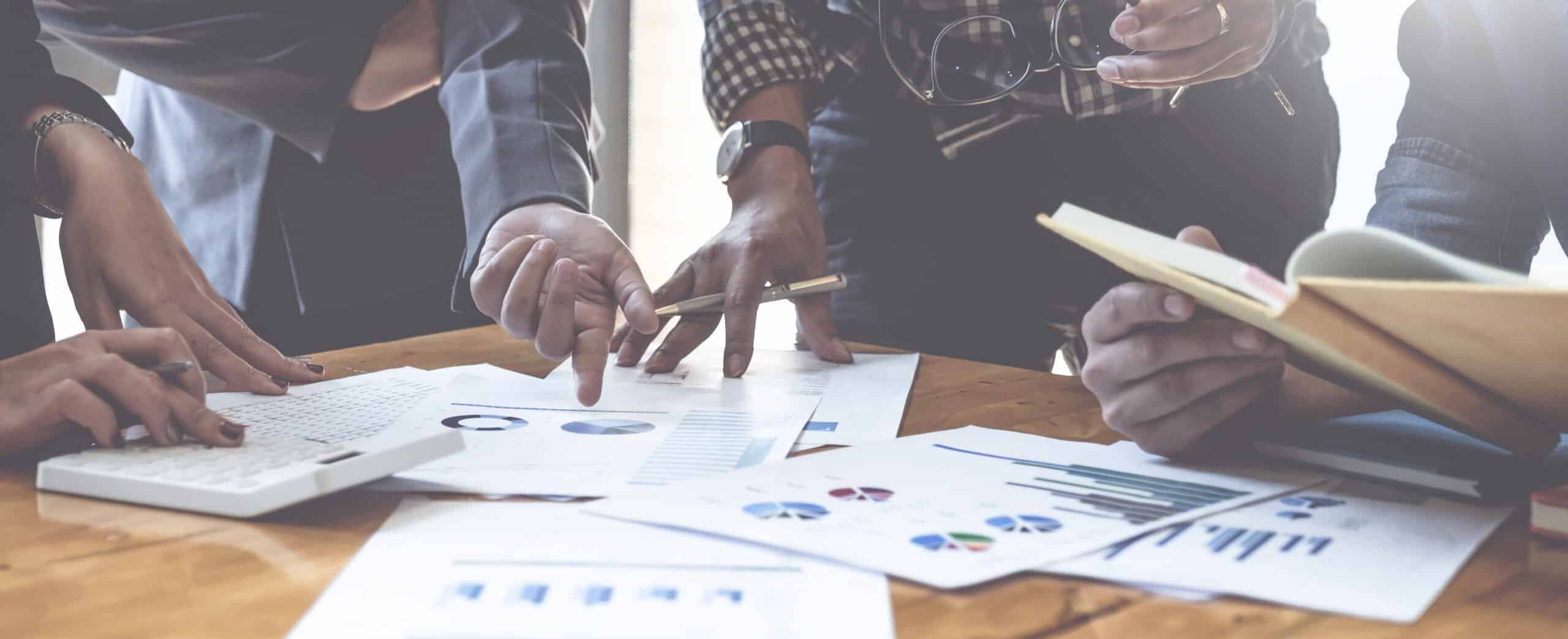 People working together at a table on a DEI gap analysis