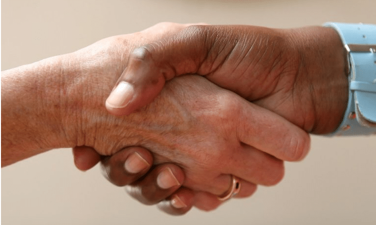 close up of 2 people shaking hands