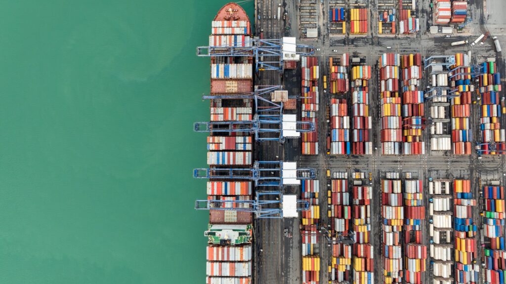 Birds eye view of a docked cargo boat with lots of storage units