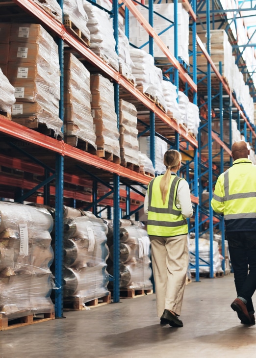 a male and female colleague taking stock of a warehouse