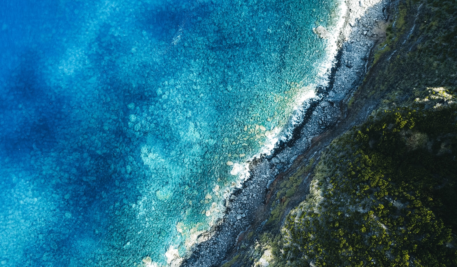 aerial shot of the sea with mountains