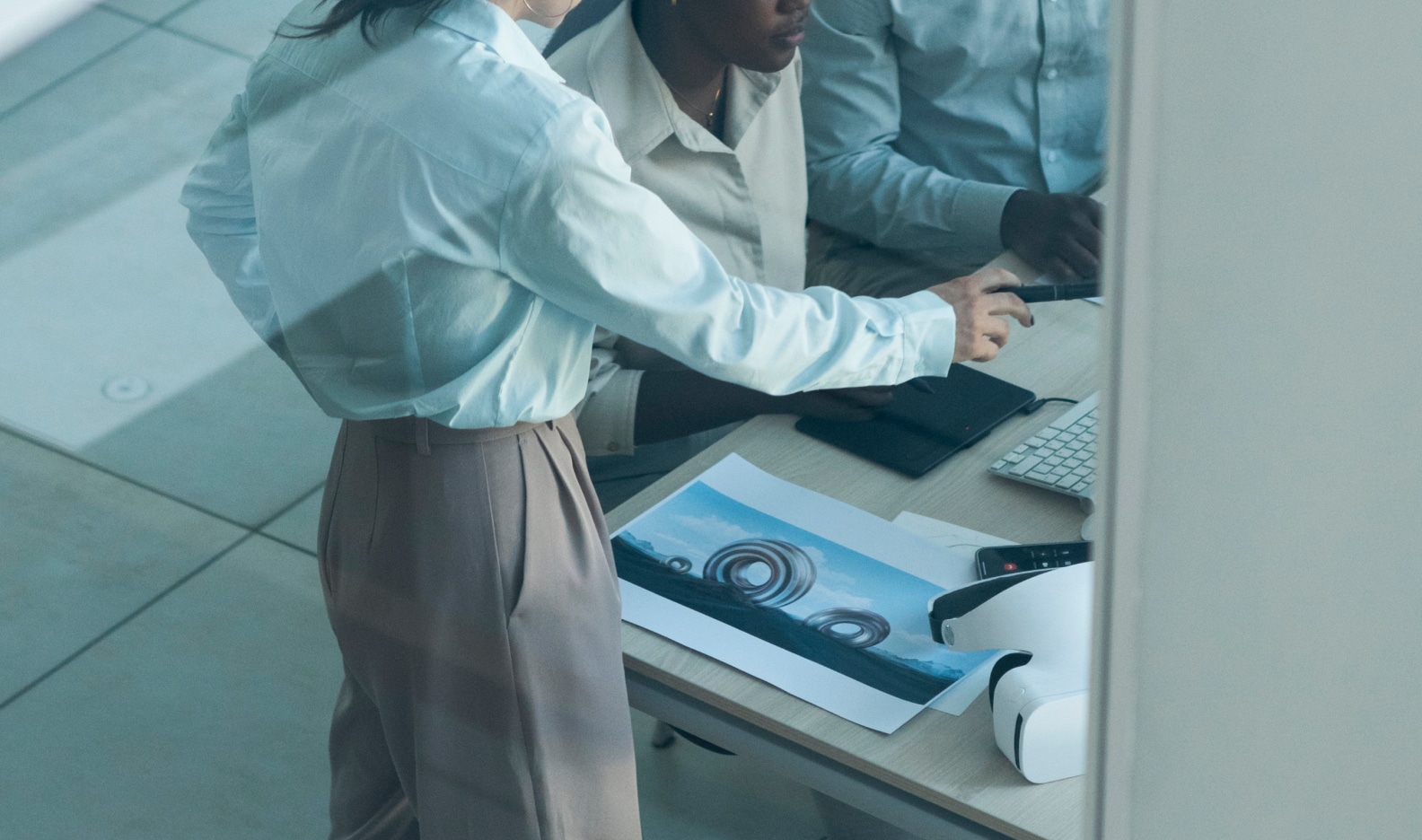 colleagues discussing a design at a computer