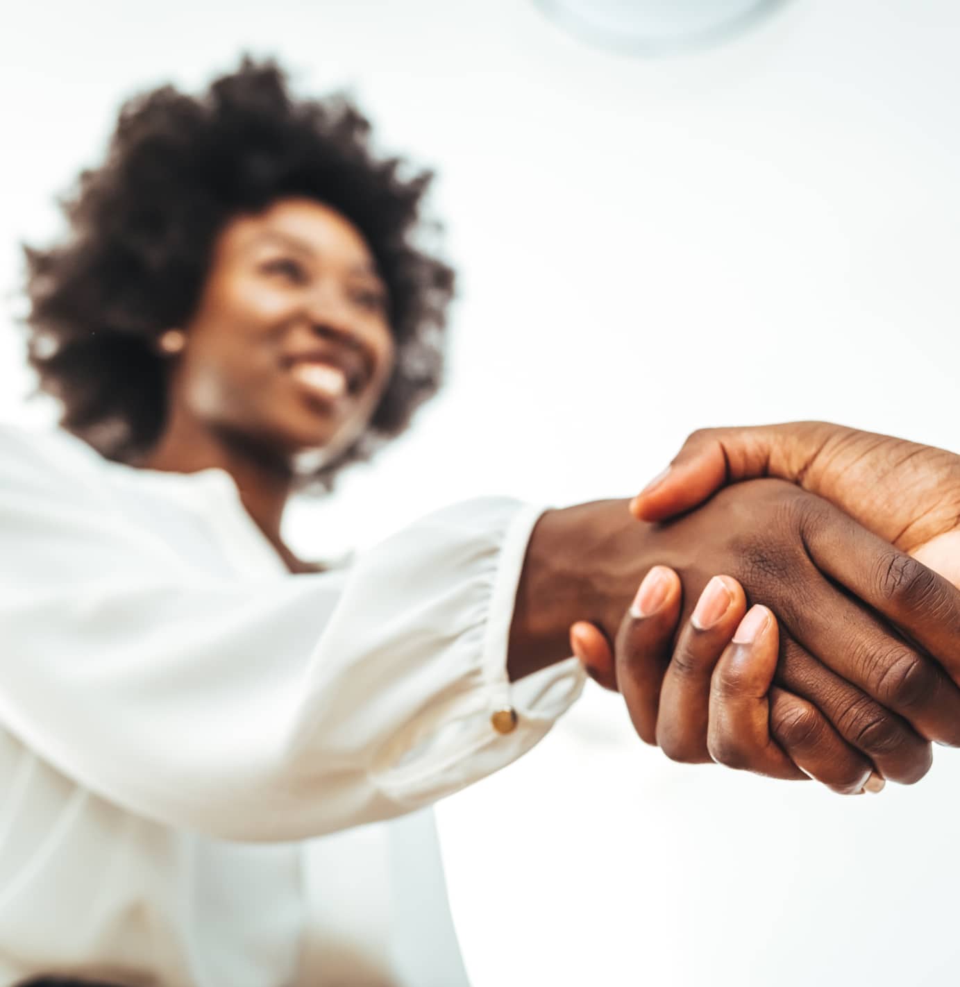 close up of a man and a woman shaking hands