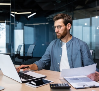 man working on a laptop at a desk