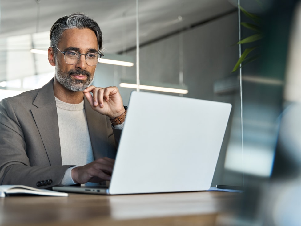 man working on his laptop in an office