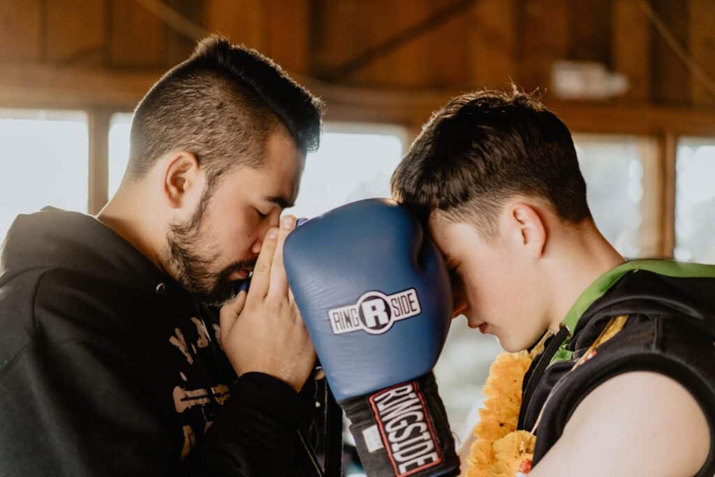 A Muaythai teacher and his student bowing to eachother