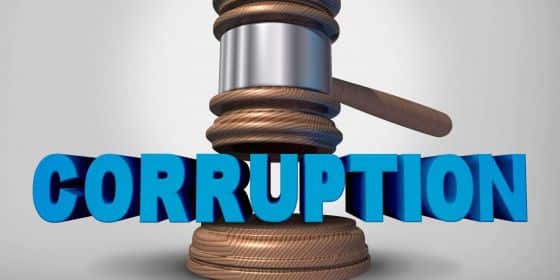 Gavel coming down on the word 'corruption'