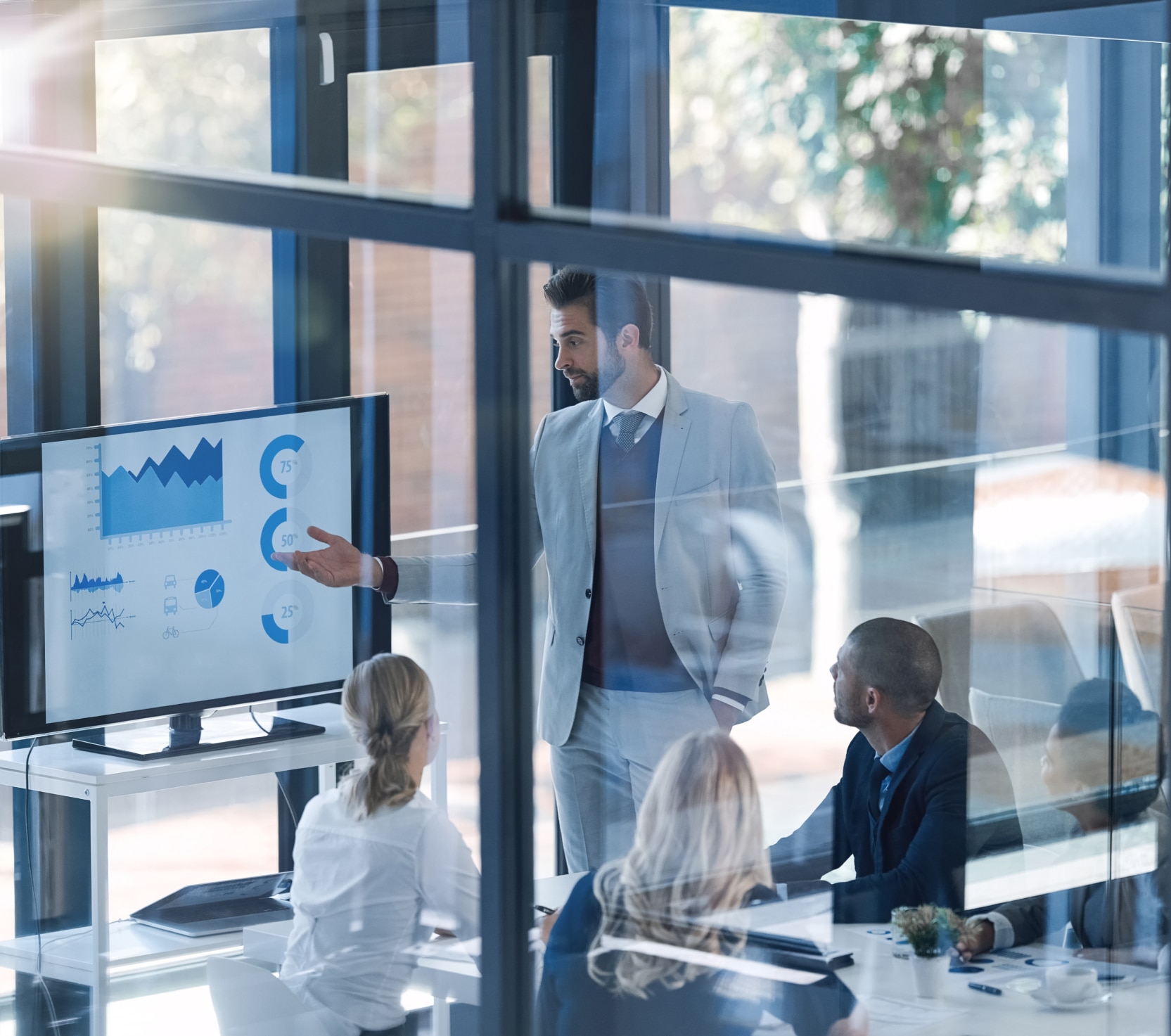 Man presenting a benchmark graph to his colleagues