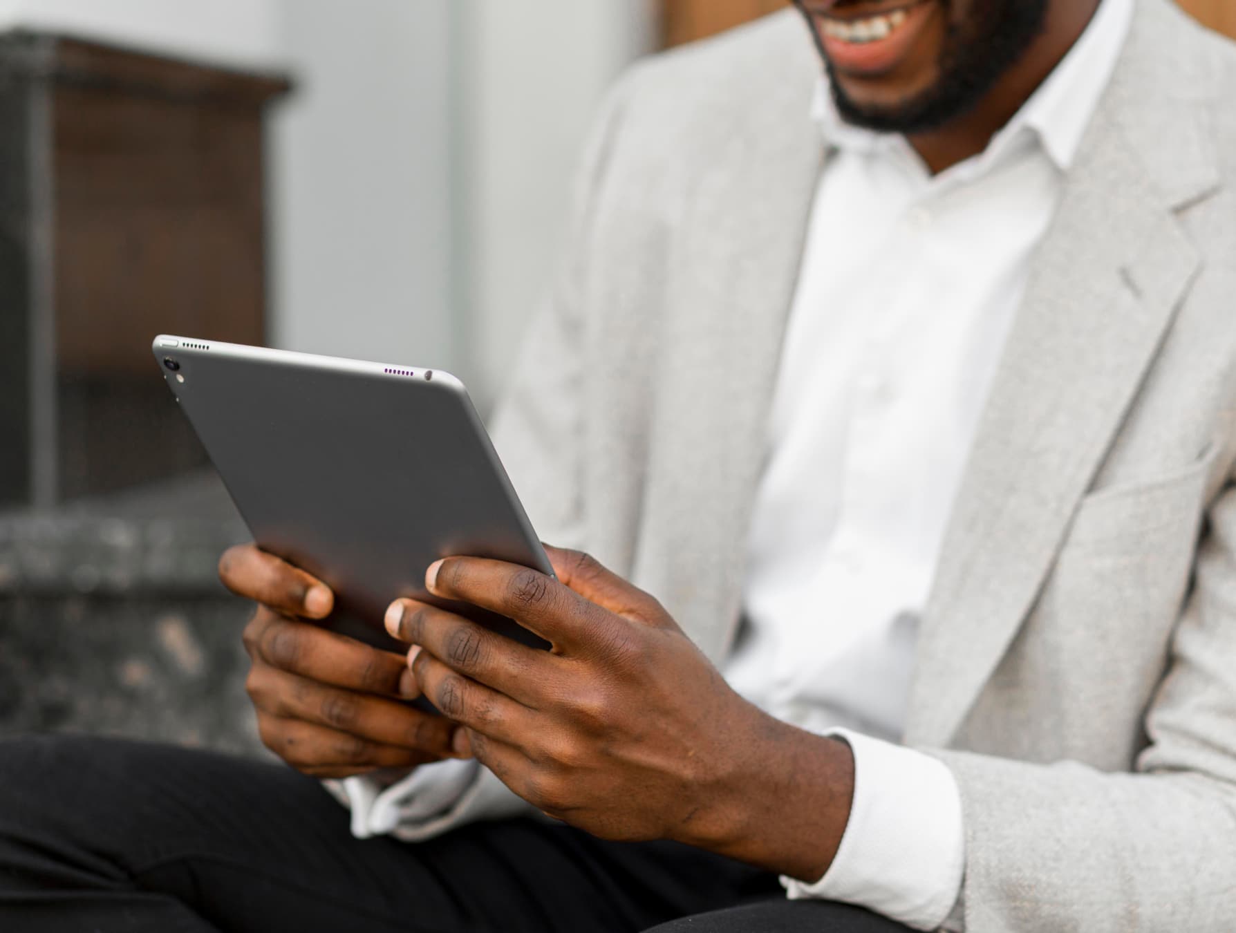 Man on a tablet device smiling