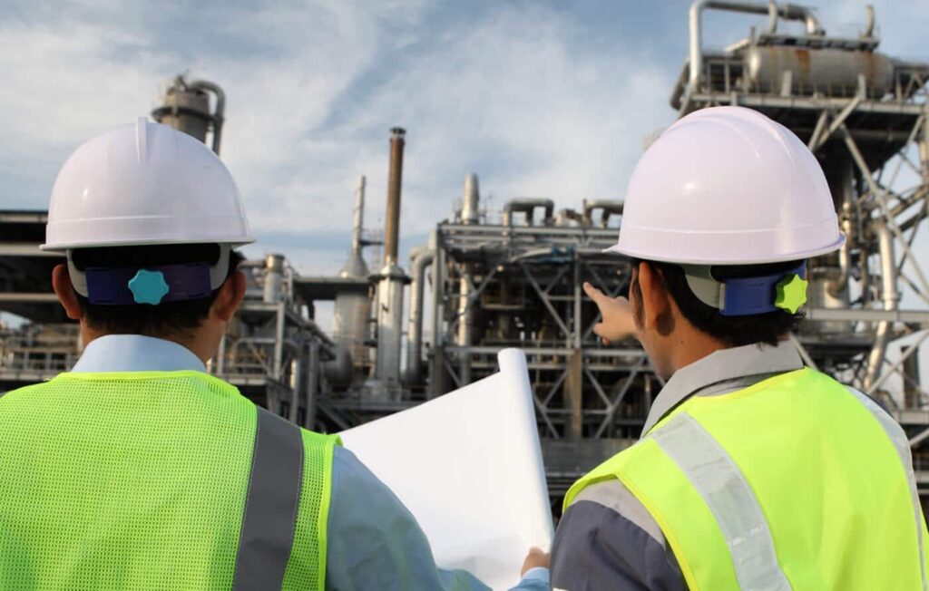 two men completing an oil refinery survey