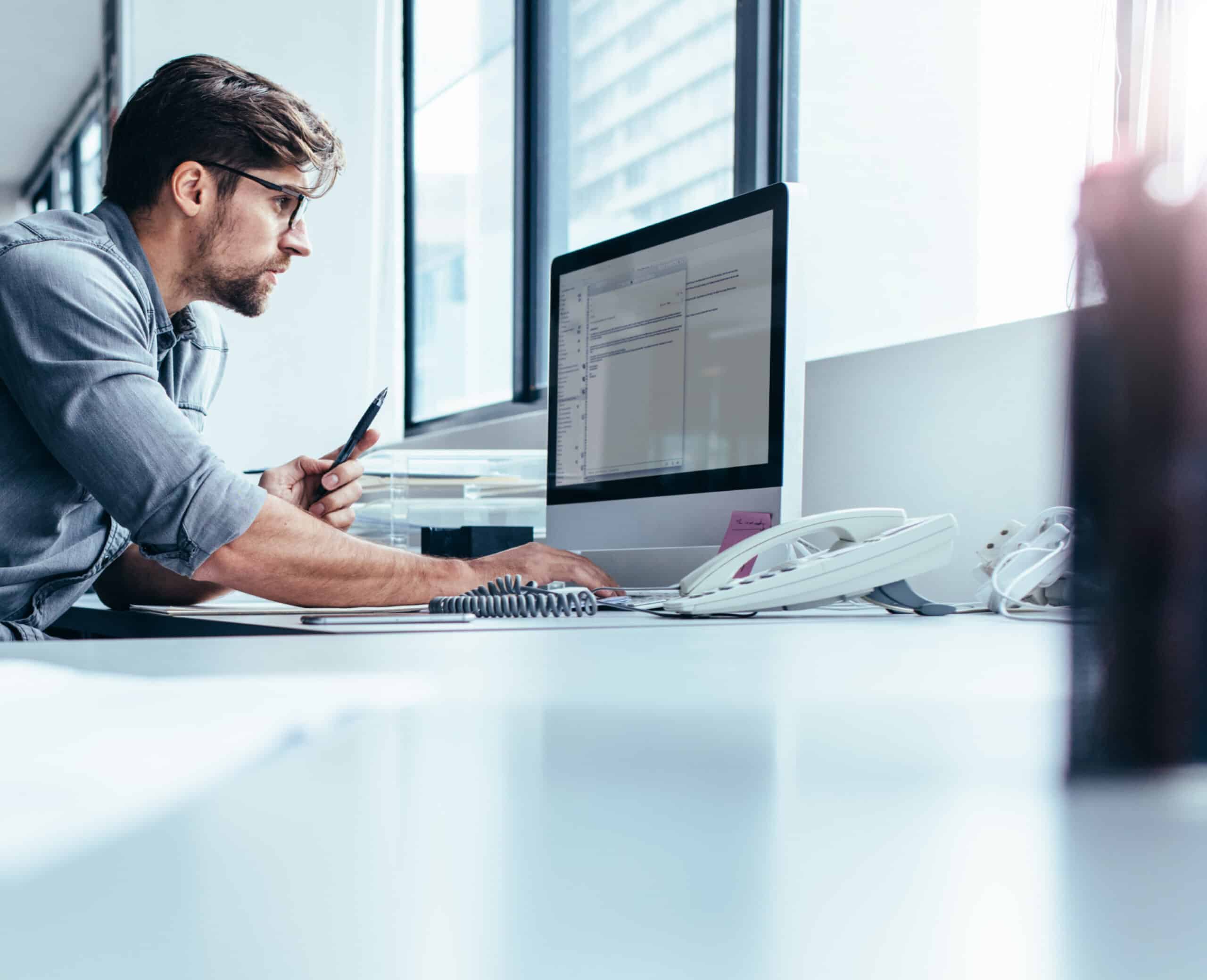 Man writing an email at his computer