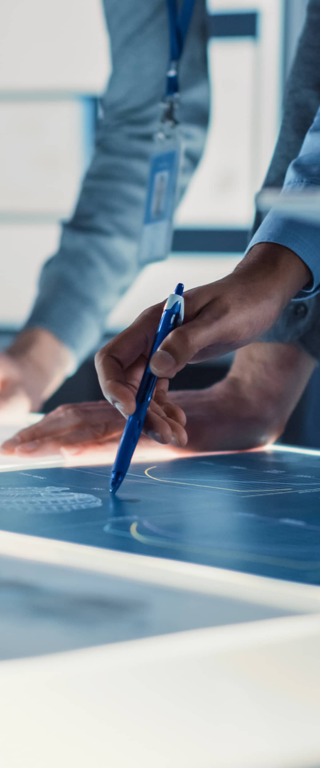 Man writing on a graph on his desk