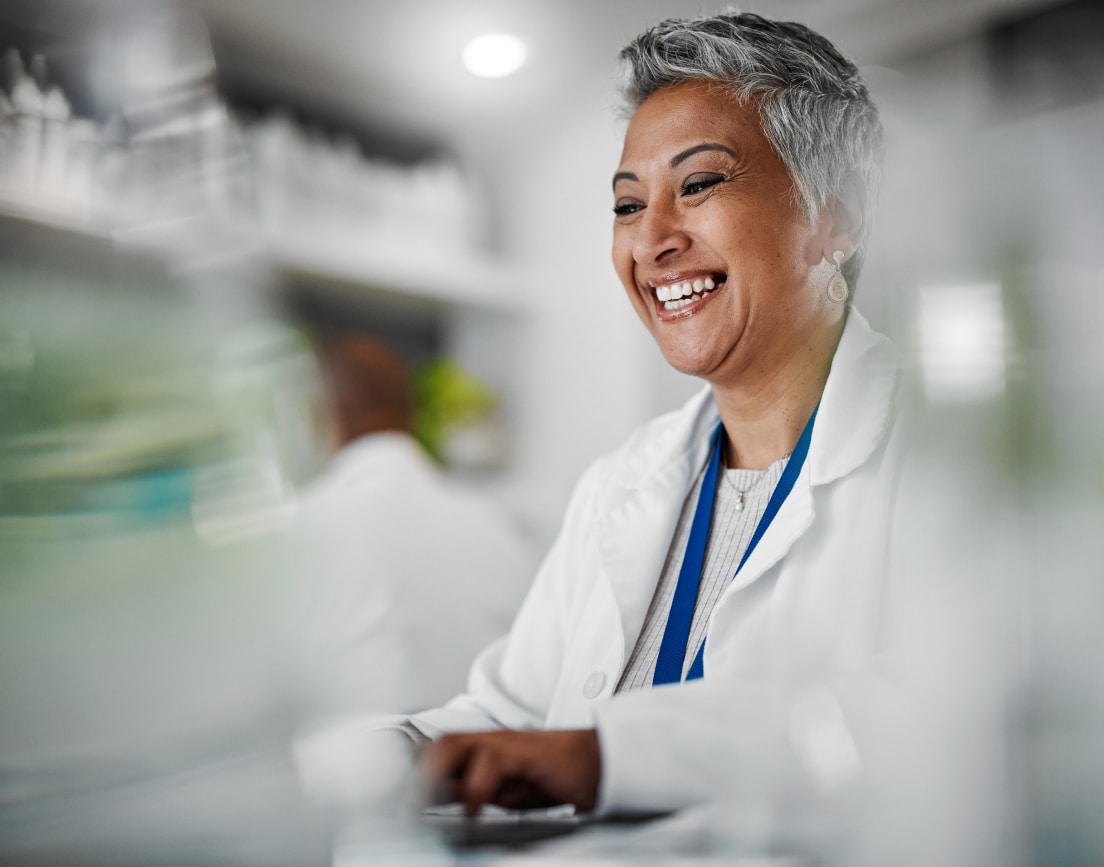 A smiling woman working in pharmaceuticals