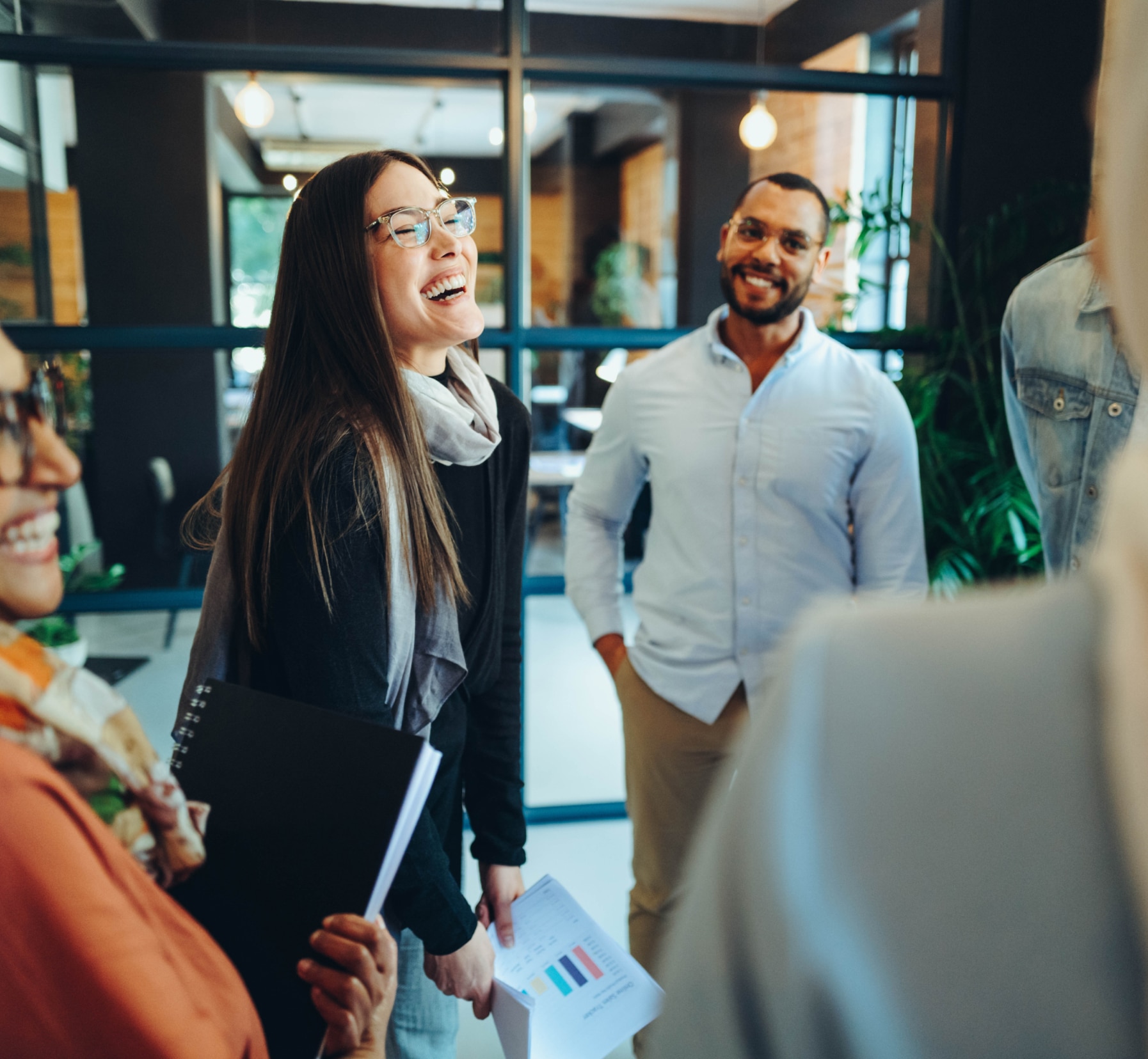 Woman laughing with her colleagues in an office