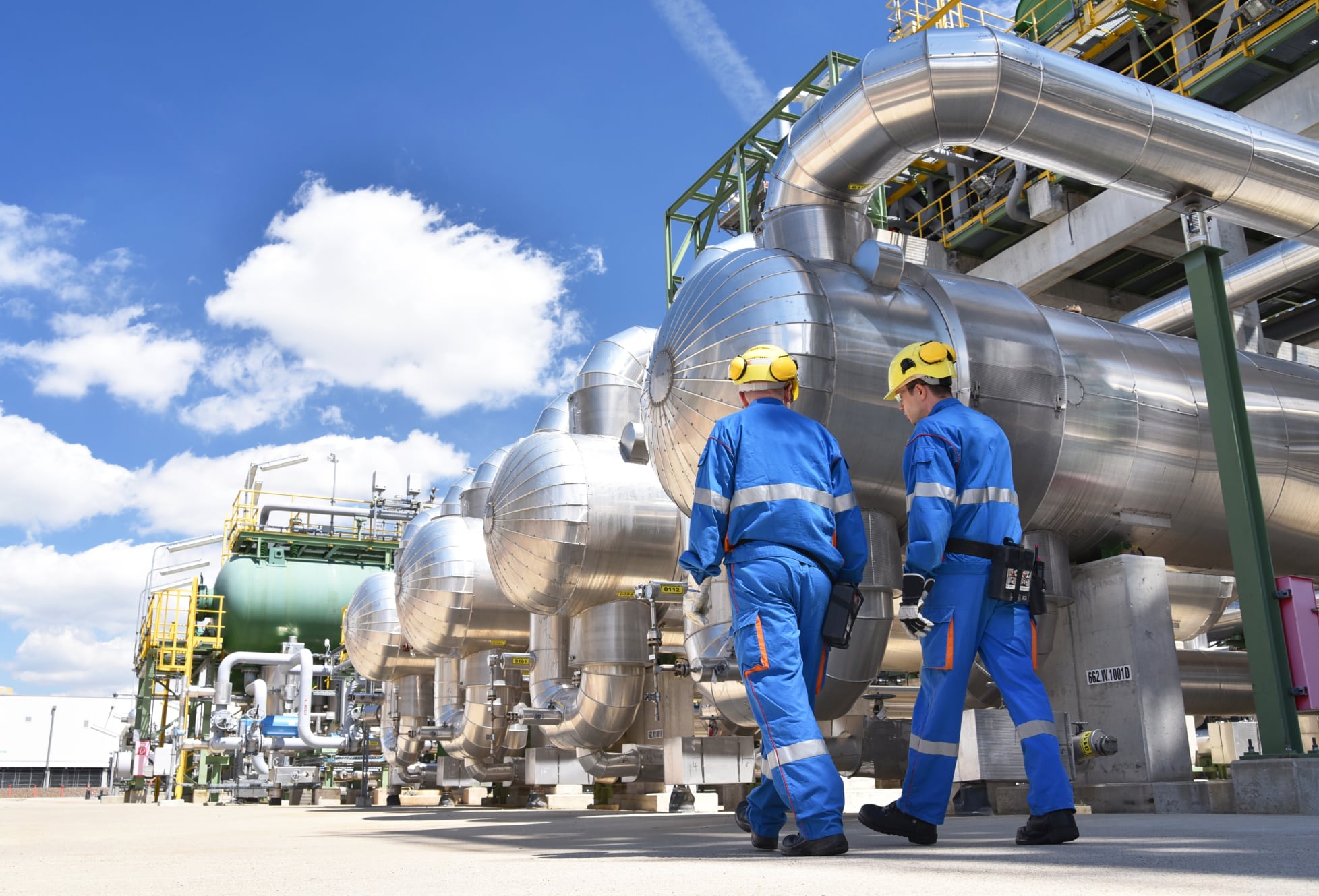 two industrial workers in a refinery