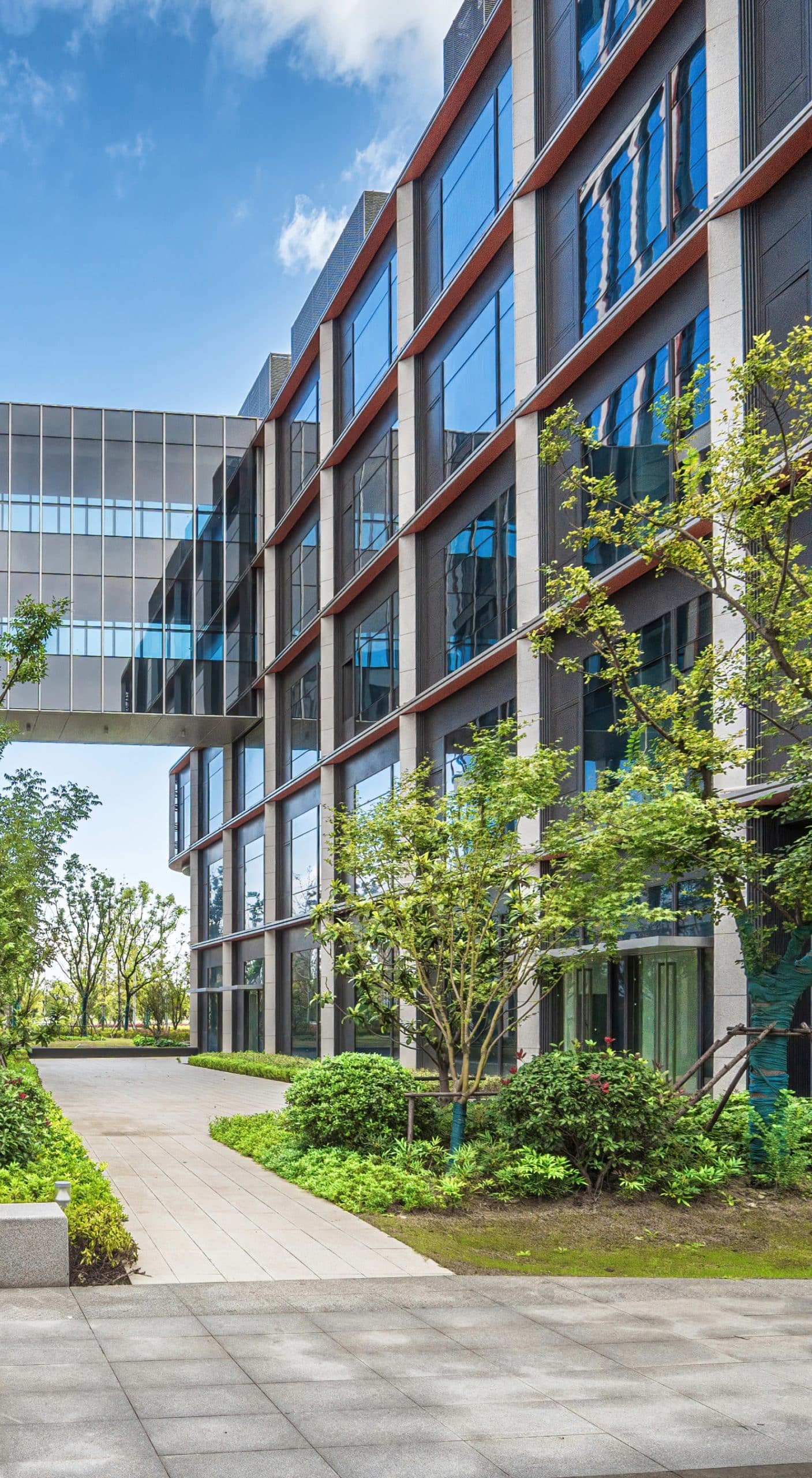 the exterior of an office building with trees outside it