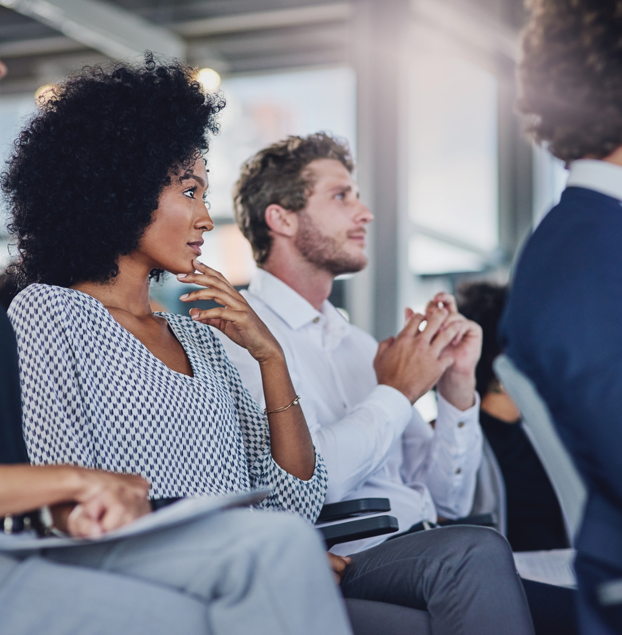 People in an audience listening to a presentation