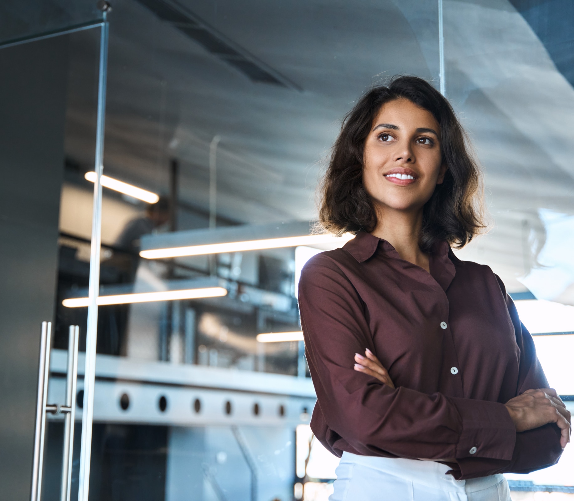 Woman with her arms crossed smiling