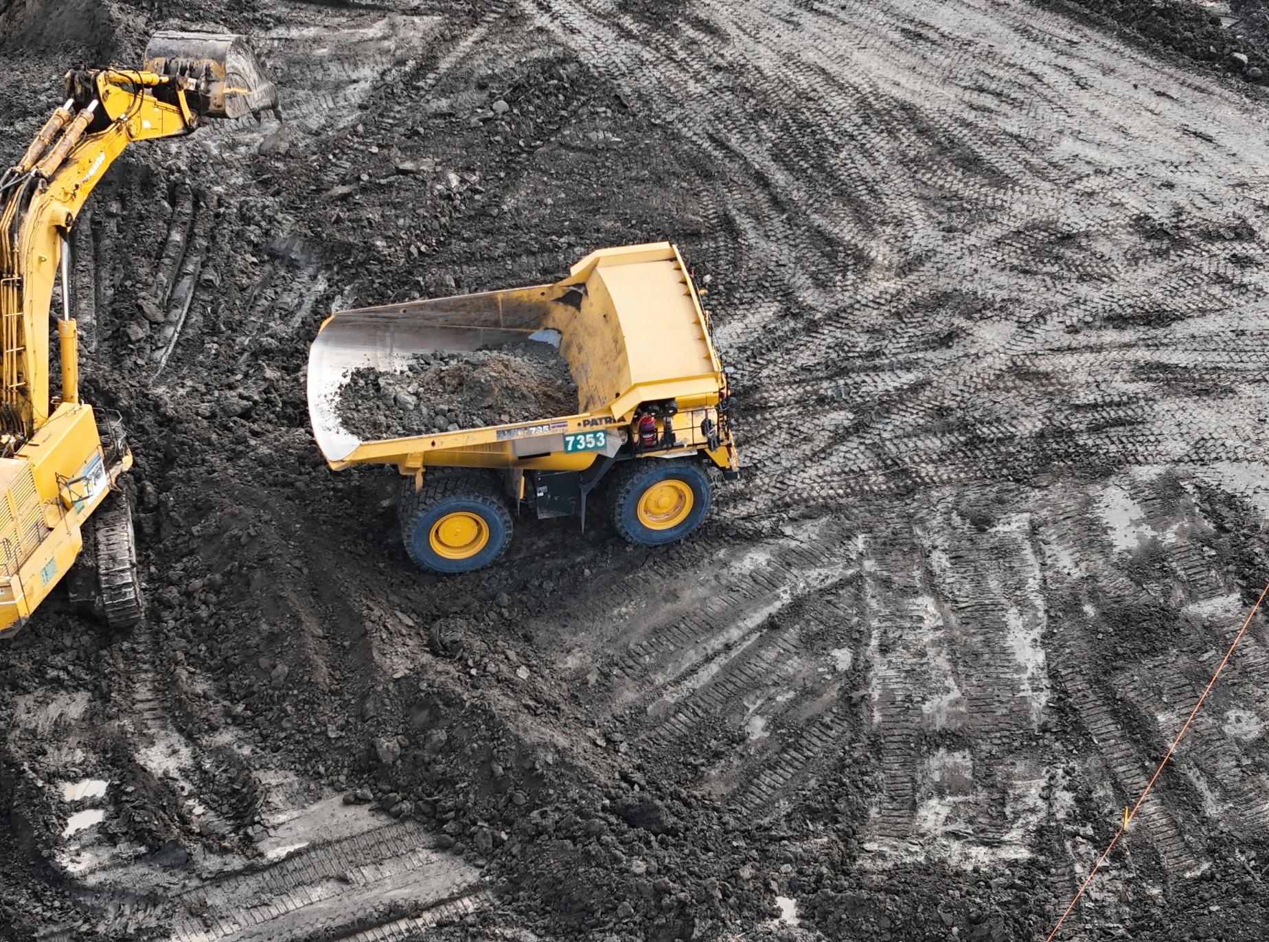 Yellow mining truck collecting dirt