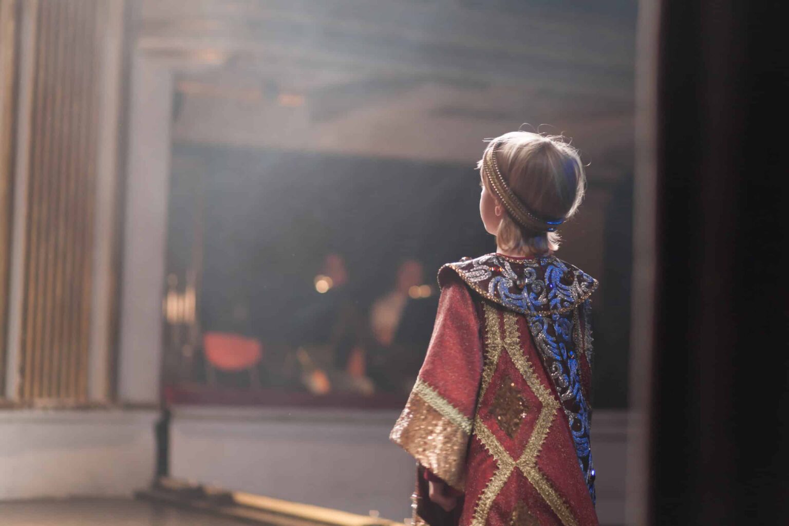 Child wearing a medieval costume acting on a stage